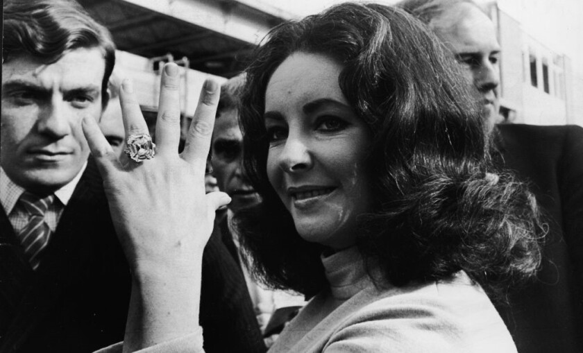 British-born actress Elizabeth Taylor shows off the 33.19 carat diamond ring given to her by husband Richard Burton. (Photo by Express Newspapers_Hulton Archive_Getty Images).jpg