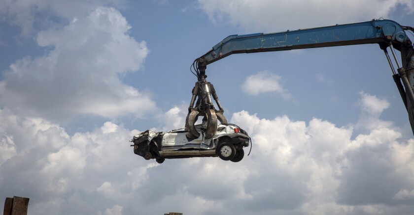 Cars Being Being Broken At A Vehicle Scrapyard